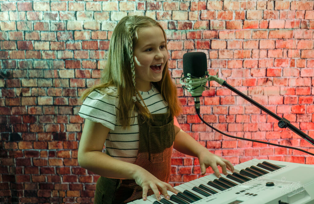 Young girl playing keyboard and singing