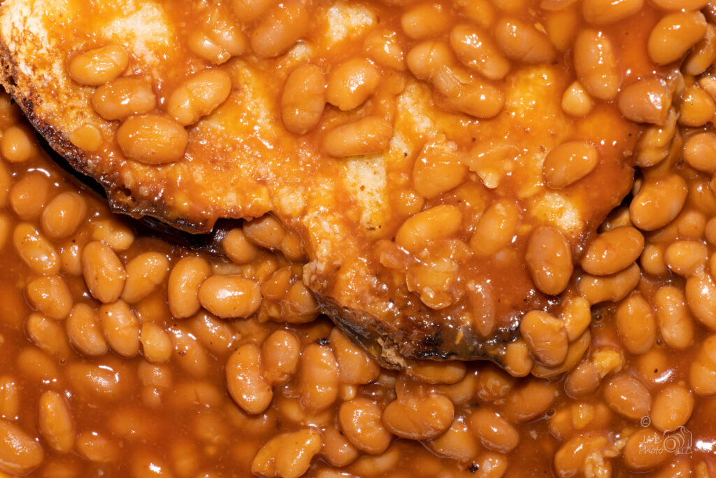 Close-up photograph of beans layered on a slice of toast